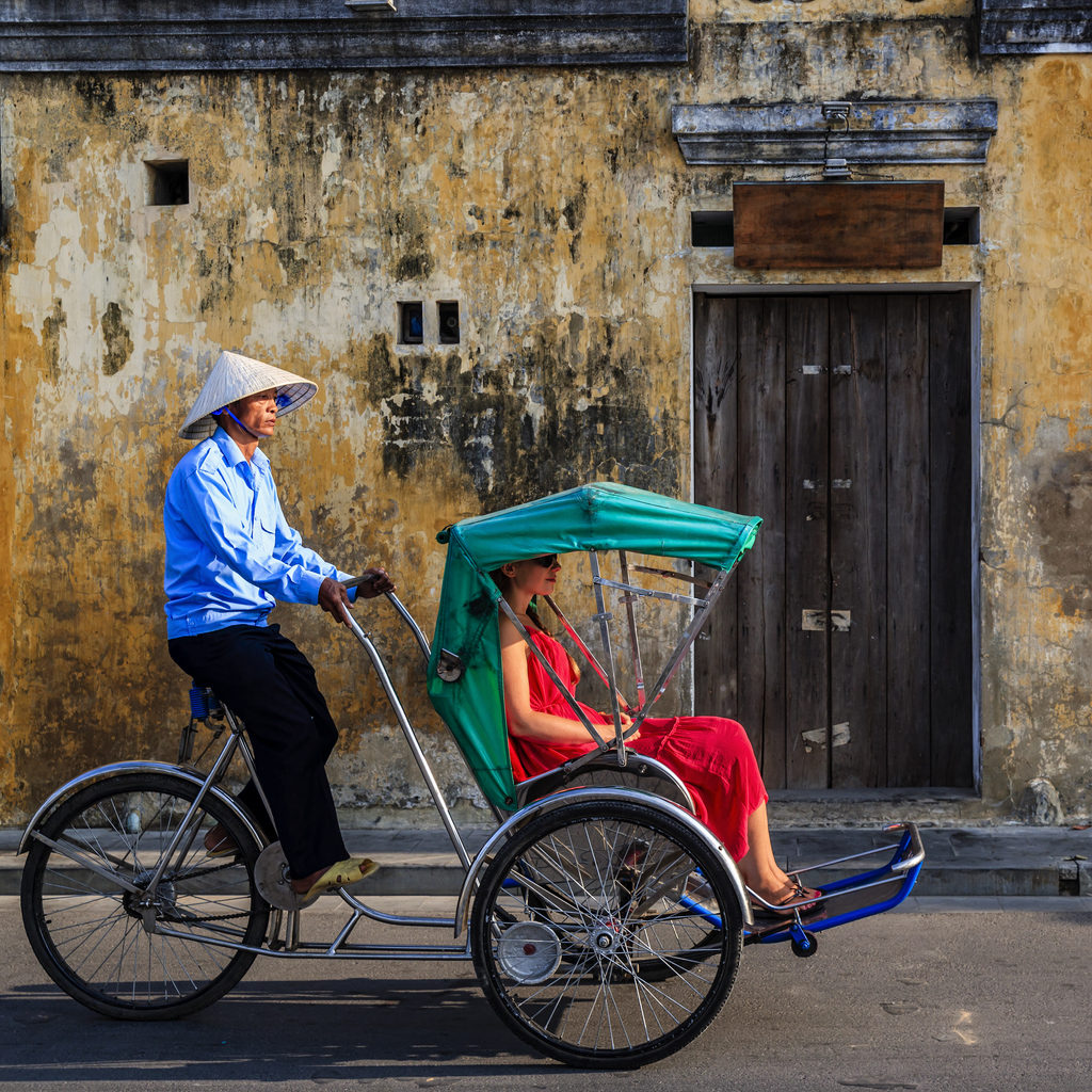 Women taking a ride in a cycle rickshaw, Hoi An, Vietnam