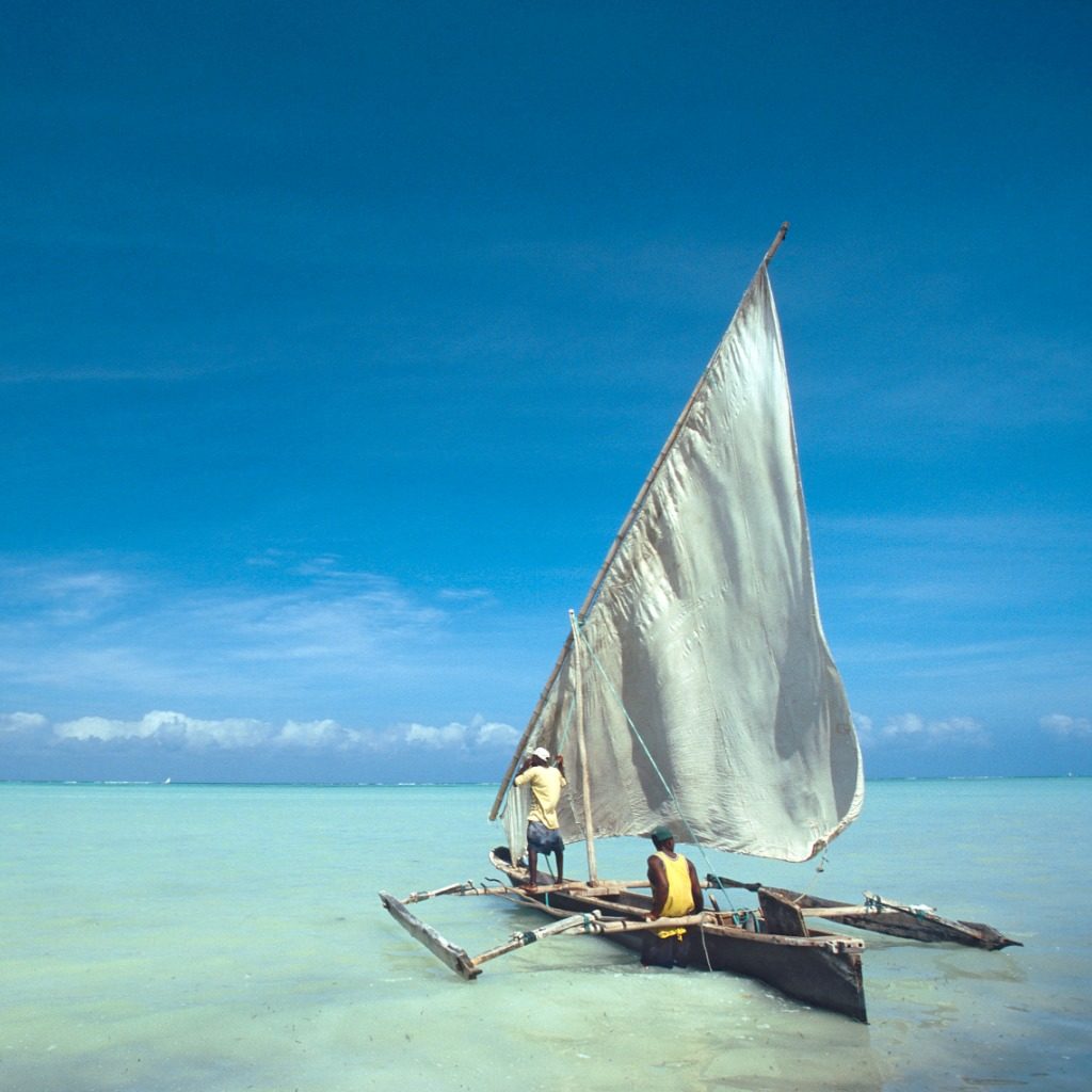 Two men sailing a traditional dhow, Zanzibar, Tanzania