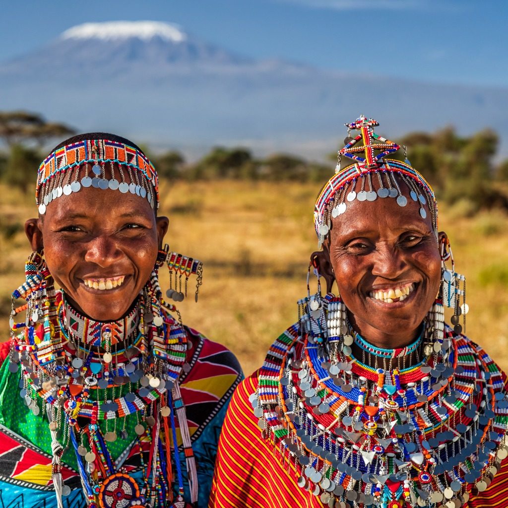 Two smiling Maasai women with Mount Kilimanjaro in the background, Kenya